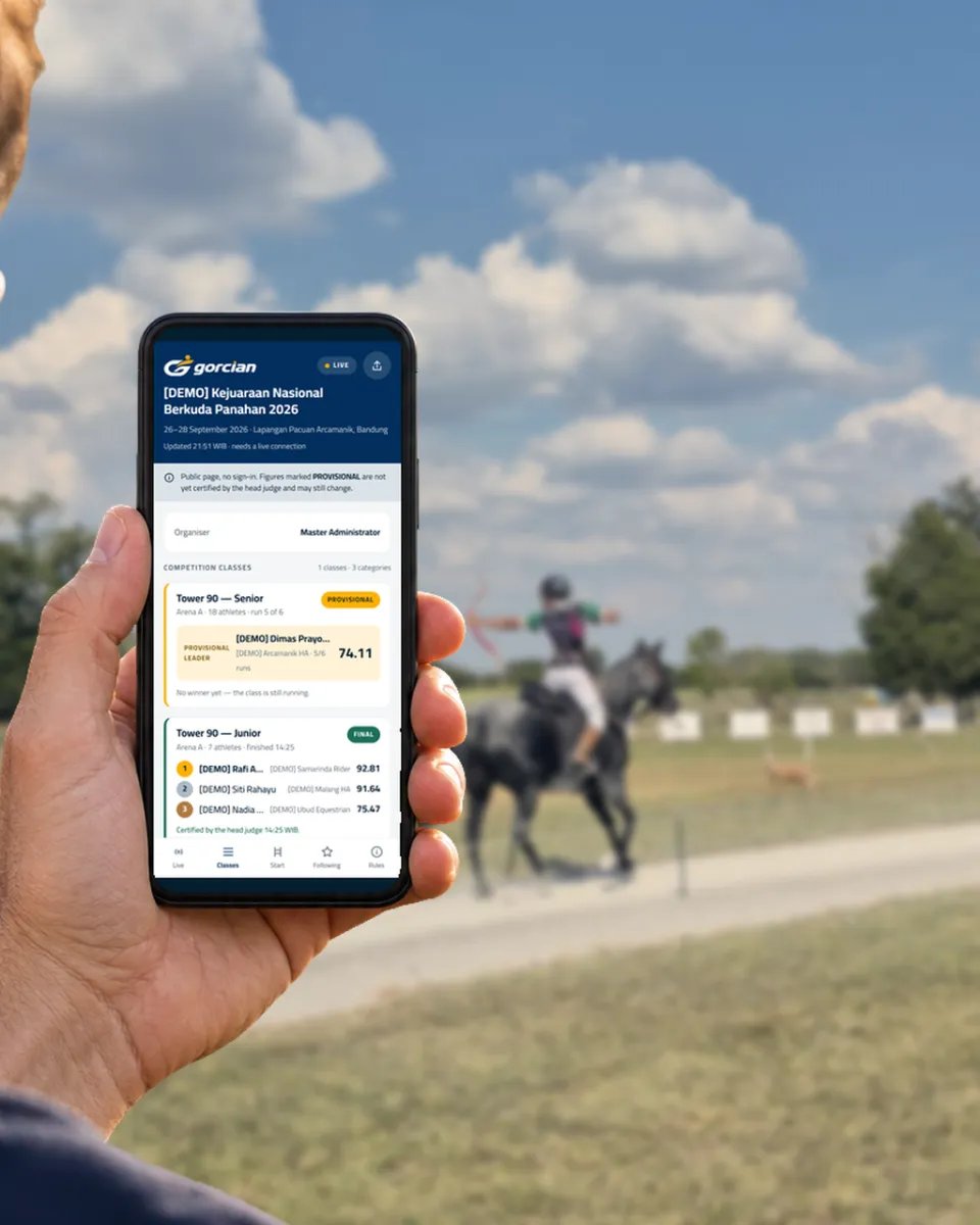 A spectator following the live scores on a phone